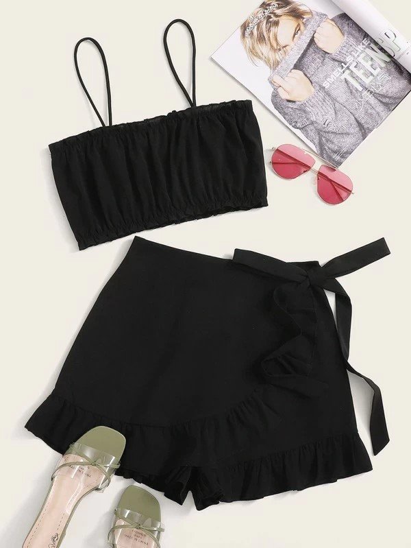Matching Black Two Piece Outfit with Black Crop Cami Top With Black Ruffle Trim Knot Shorts. Love this set with a cropped black cami top and matching black ruffle trim know shorts.