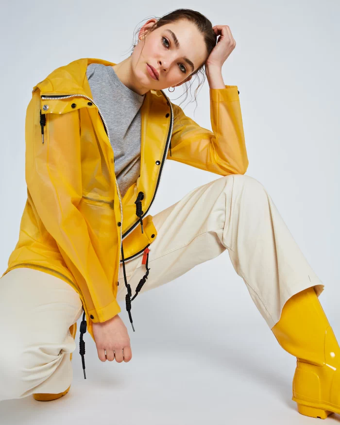 Women's Yellow Hunter Waterproof Vinyl Smock Rain Jacket. Women's Hooded Yellow Vinyl Rain Jacket. Fashioned in a stylish yellow waterproof vinyl, this navy rain jacket with Hood for women.